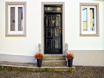 Haustür zwischen zwei Fenstern